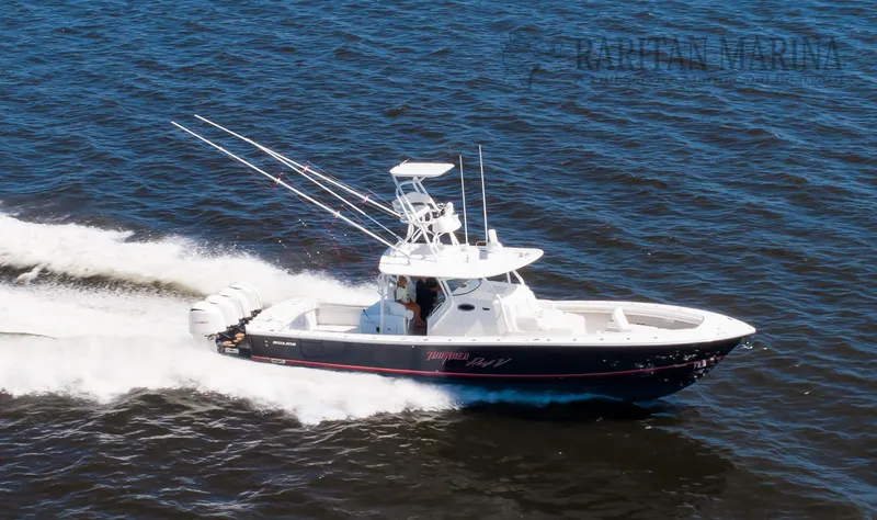 Slide: The Image of 2016 Regulator 41 boat cruising on open water with triple outboard engines. - 17