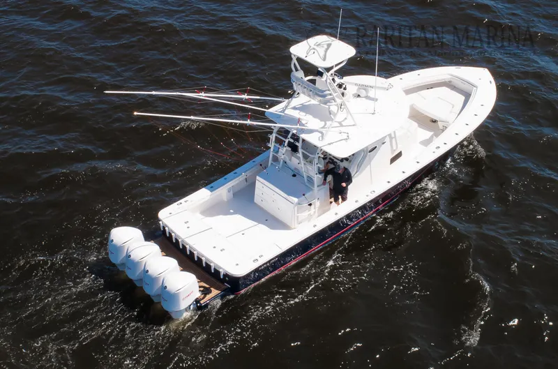 Slide: The Image of 2016 Regulator 41 boat cruising on open water with multiple outboard engines. - 26