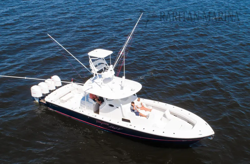 Slide: The Image of 2016 Regulator 41 boat on water with fishing rods and multiple engines. - 31