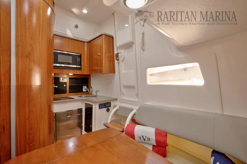 Slide: The Image of Interior of 2016 Regulator 41 boat with kitchenette and seating area. - 35
