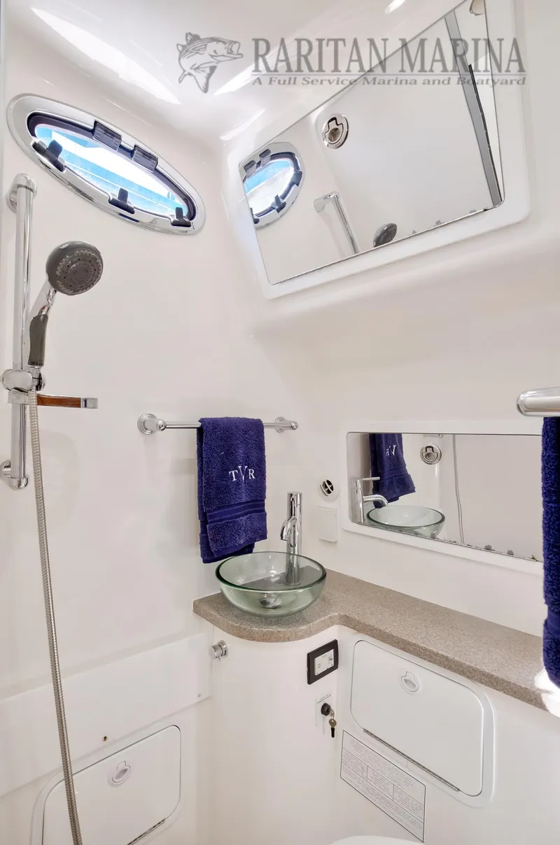 Slide: The Image of 2016 Regulator 41 boat bathroom with modern fixtures and glass sink. - 39