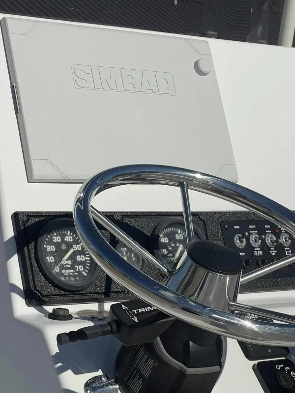Slide: The Image of 2023 Blazer 2220 Fisherman dashboard with Simrad display and steering wheel. - 13