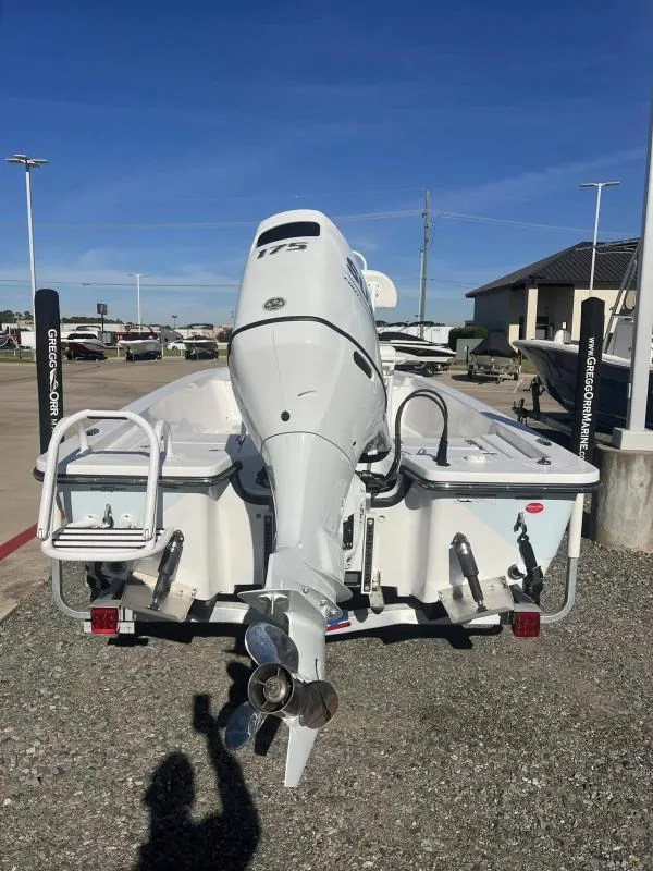 Slide: The Image of 2023 Blazer 2220 Fisherman boat with powerful outboard motor in a marina setting. - 4