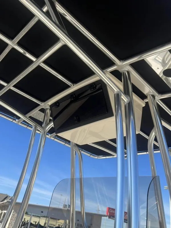 Slide: The Image of 2024 Bulls Bay 200CC boat T-top frame with electronics box, under clear blue sky. - 10