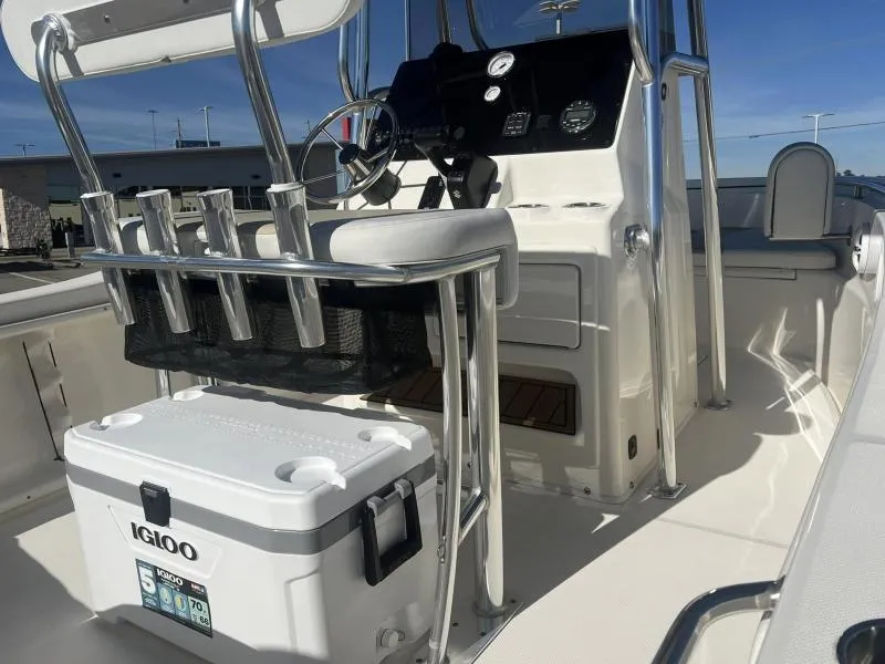 Slide: The Image of 2024 Bulls Bay 200CC boat interior with console, seating, and Igloo cooler. - 13