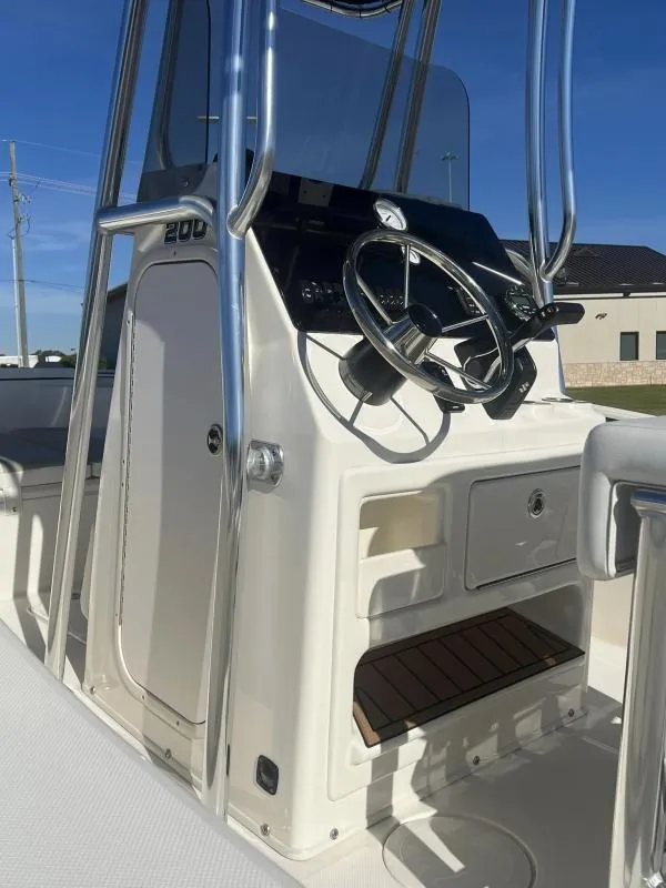 Slide: The Image of 2024 Bulls Bay 200CC boat console with steering wheel and controls. - 17