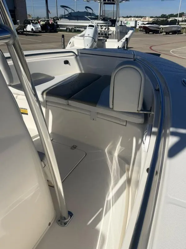 Slide: The Image of 2024 Bulls Bay 200CC boat interior with seating and storage, displayed outdoors. - 8