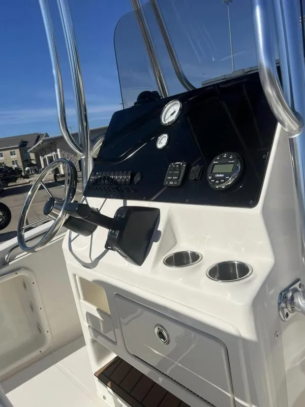 Slide: The Image of 2024 Bulls Bay 200CC boat console with steering wheel and gauges. - 9