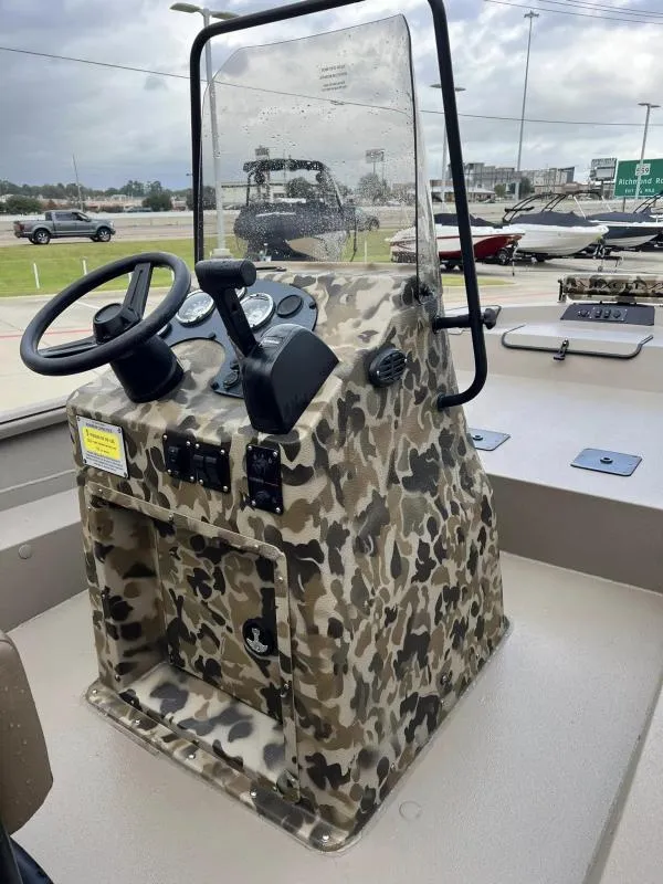Slide: The Image of 2024 Excel Boats 1860 STALKER with camo console and steering wheel. - 12