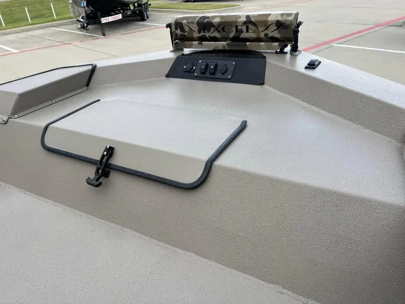 Slide: The Image of 2024 Excel Boats 1860 STALKER deck with control panel and storage compartment. - 9