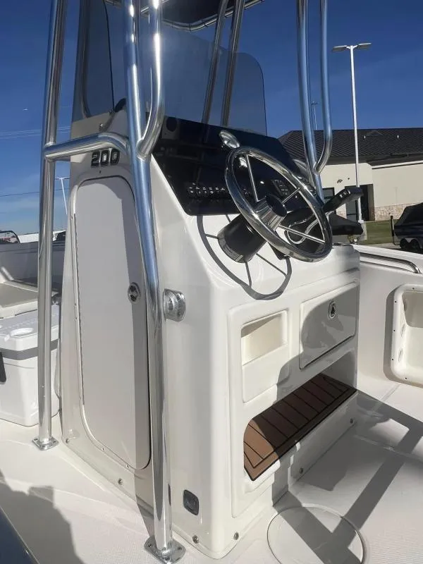 Slide: The Image of 2024 Bulls Bay 200 CC boat console with steering wheel and controls. - 16