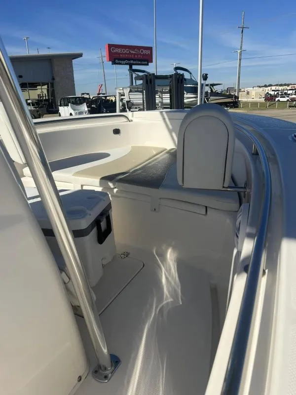 Slide: The Image of 2024 Bulls Bay 200 CC boat interior with seating and storage, displayed at dealership. - 8