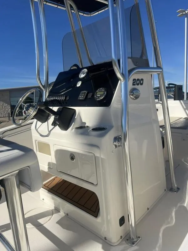Slide: The Image of 2024 Bulls Bay 200 CC boat console with steering wheel and controls. - 9