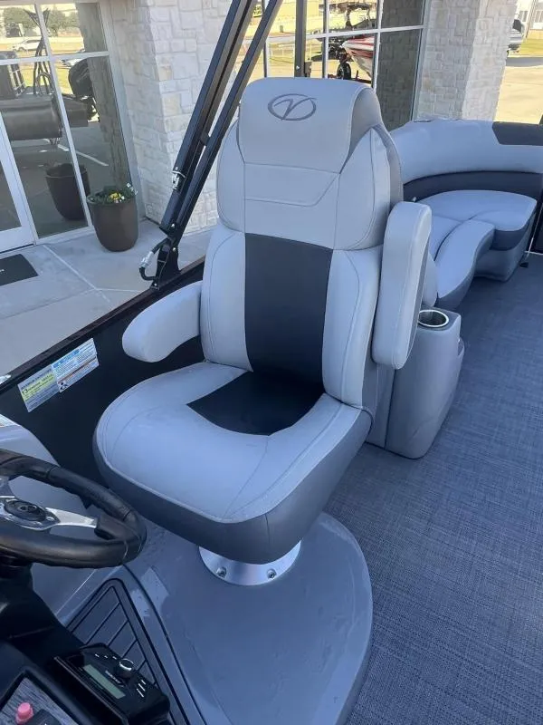 Slide: The Image of 2024 Veranda VR22RC boat interior with plush captain's chair and steering console. - 14