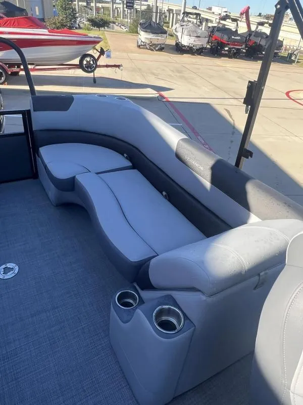 Slide: The Image of 2024 Veranda VR22RC boat interior with gray seating and cup holders. - 16