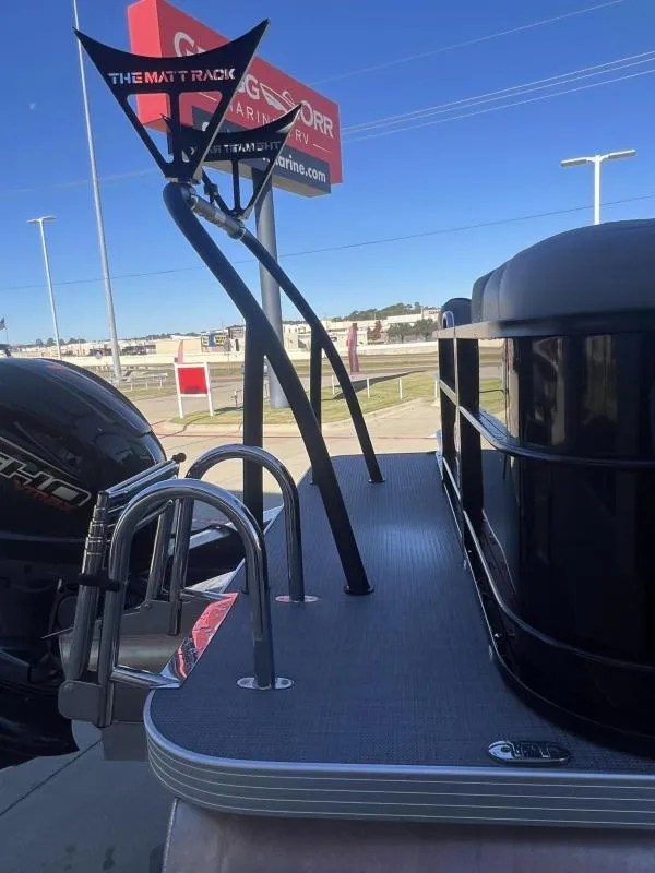 Slide: The Image of 2024 Veranda VR22RC pontoon boat with motor and ladder, displayed at a dealership. - 25