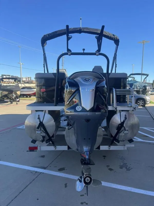 Slide: The Image of 2024 Veranda VR22RC pontoon boat with outboard motor, parked outdoors. - 3