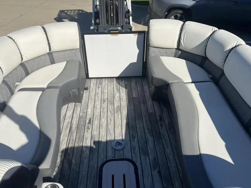 Slide: The Image of 2024 Veranda VP25RC pontoon boat interior with plush seating and wood-style flooring. - 10