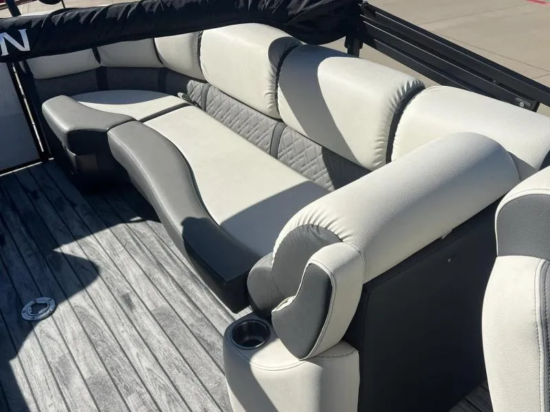 Slide: The Image of 2024 Veranda VP25RC boat interior with plush gray seating and wood-style flooring. - 13