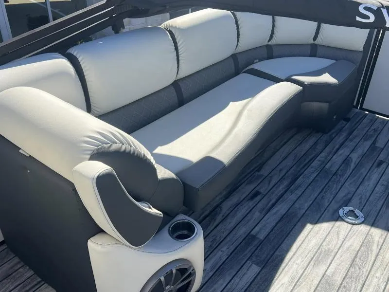 Slide: The Image of 2024 Veranda VP25RC boat interior with plush seating and wood-style flooring. - 14