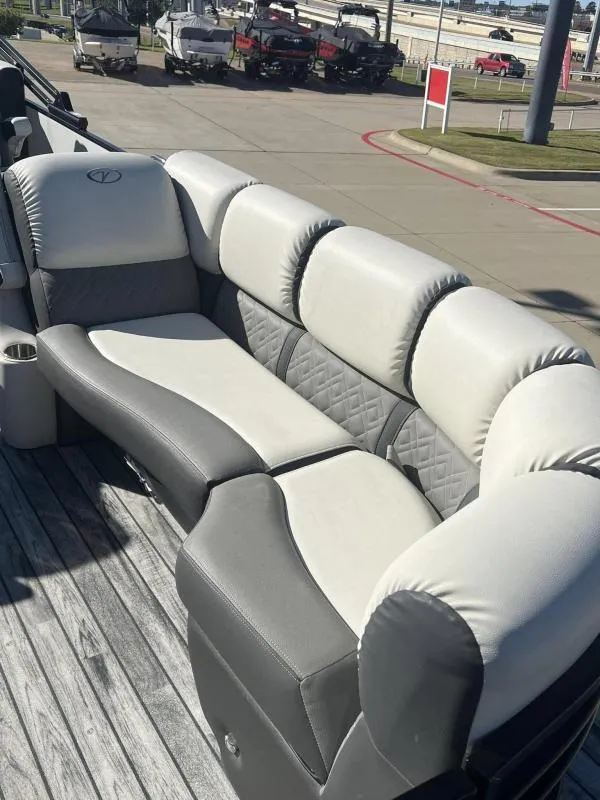 Slide: The Image of 2024 Veranda VP25RC boat with luxurious gray and white seating on a wooden deck. - 8