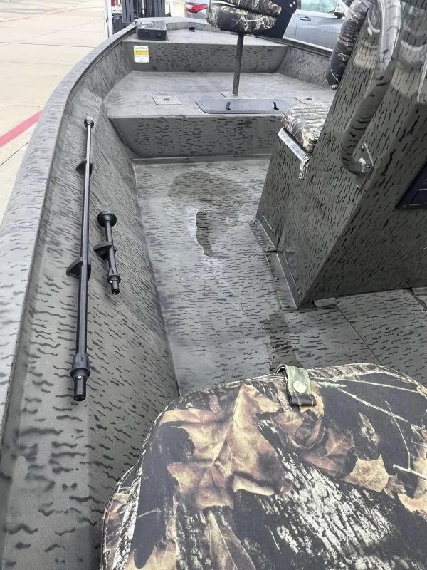 Slide: The Image of 2023 War Eagle 961 Blackhawk boat interior with camouflage seating and flooring. - 13