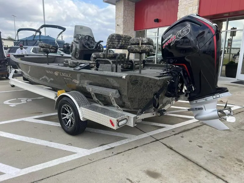 Slide: The Image of 2023 War Eagle 961 Blackhawk boat with powerful outboard motor on a trailer. - 3