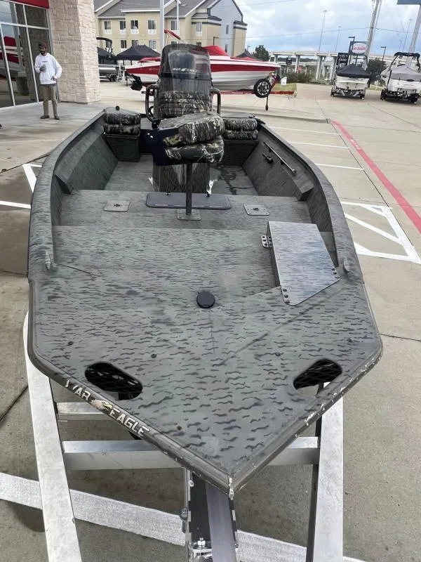 Slide: The Image of 2023 War Eagle 961 Blackhawk boat on display in a parking lot. - 8