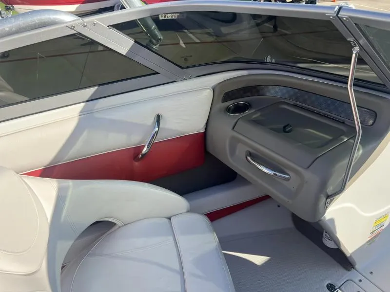 Slide: The Image of Interior of a 2011 Crownline Boats 185 SS, featuring white and red seating. - 11