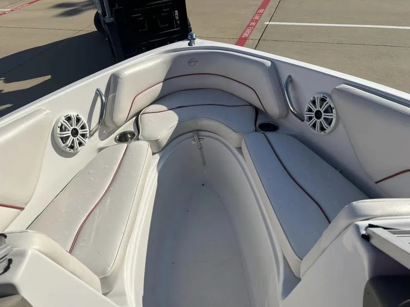 Slide: The Image of 2011 Crownline 185 SS boat interior with white seating and speakers. - 12