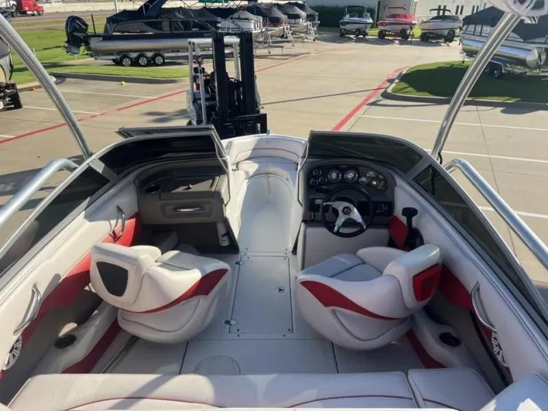 Slide: The Image of 2011 Crownline Boats 185 SS interior with red and white seating, dashboard, and steering wheel. - 14
