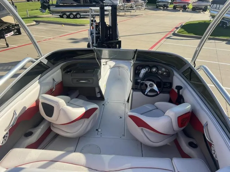 Slide: The Image of 2011 Crownline Boats 185 SS interior with red and white seating, dashboard, and steering wheel. - 8