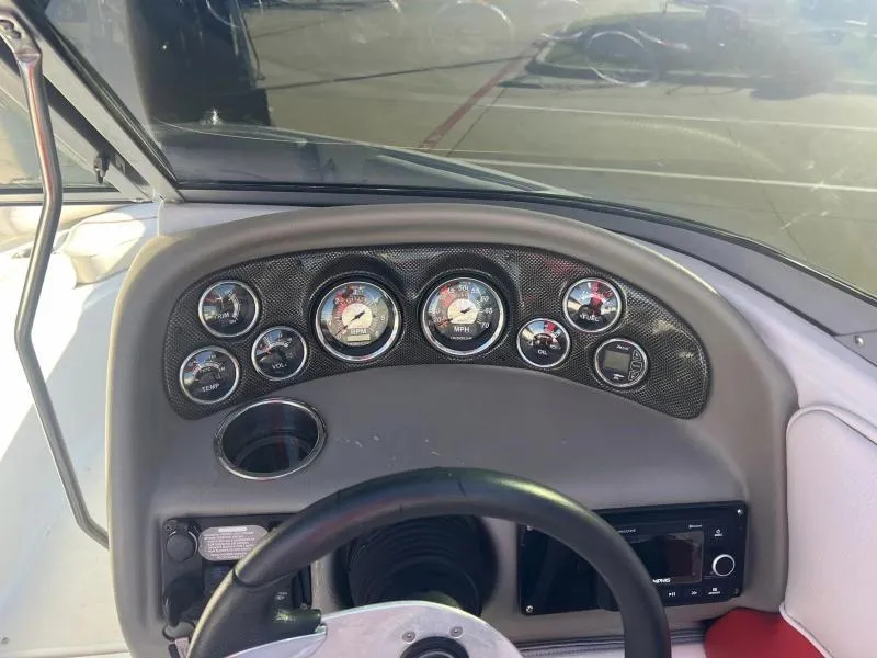 Slide: The Image of Dashboard of a 2011 Crownline Boats 185 SS, featuring gauges and controls. - 9