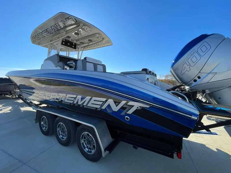 Slide: The Image of 2020 Statement 350 Open boat on trailer with powerful engines, sleek design. - 10