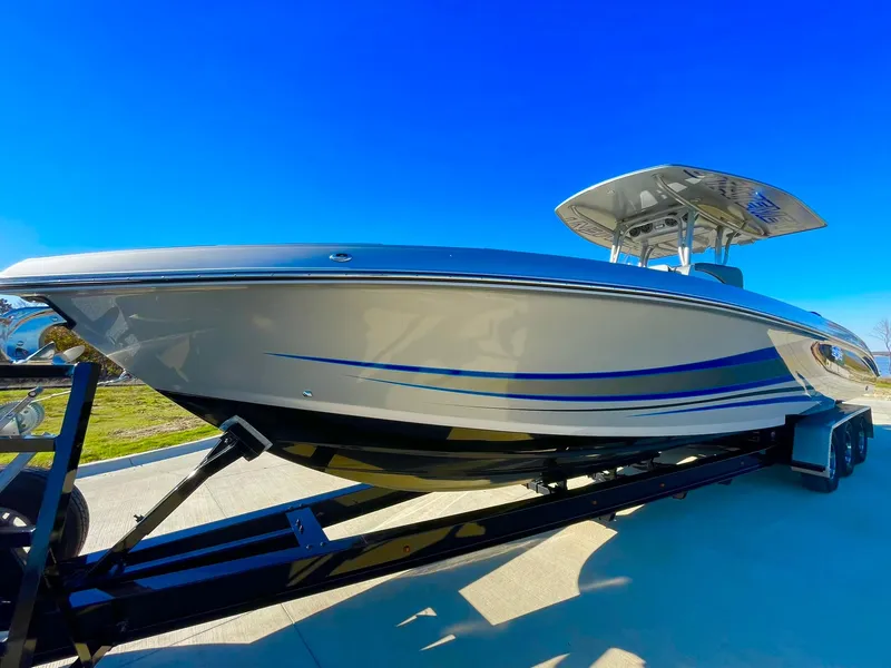 Slide: The Image of 2020 Statement 350 Open boat on trailer under clear blue sky. - 11