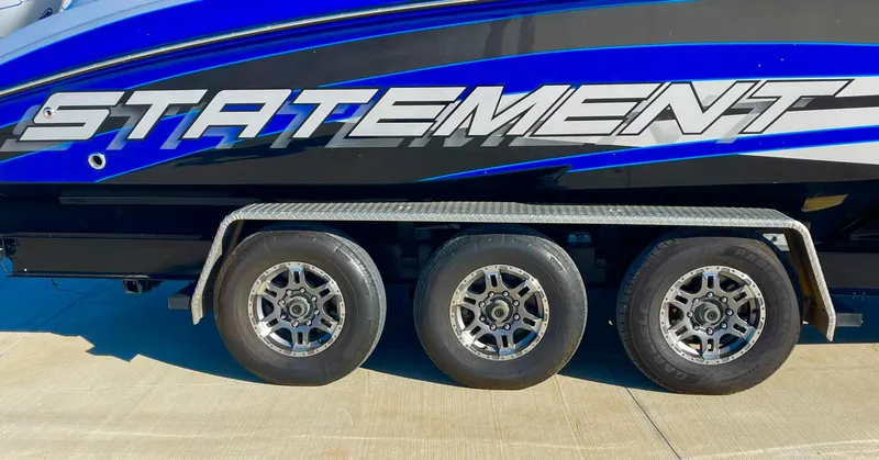Slide: The Image of 2020 Statement 350 Open boat on trailer with three wheels. - 12