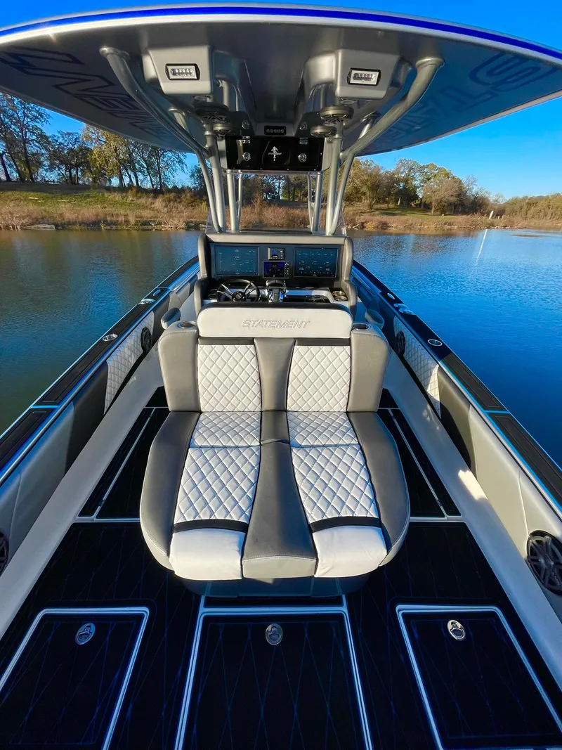 Slide: The Image of 2020 Statement 350 Open boat interior with luxurious seating on a calm lake. - 21