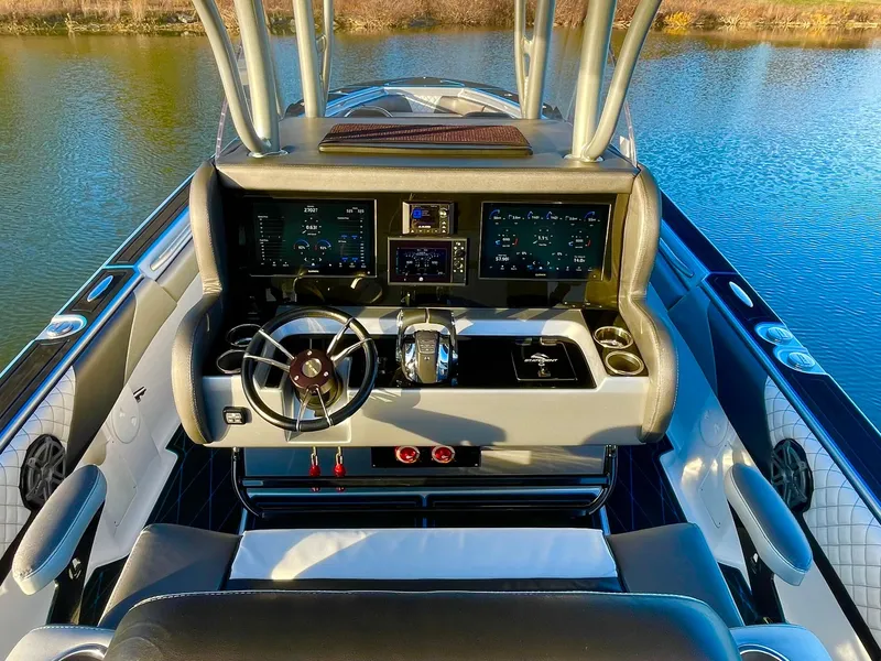 Slide: The Image of 2020 Statement 350 Open boat dashboard with advanced controls on a calm water backdrop. - 22