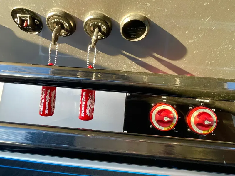 Slide: The Image of Control panel of a 2020 Statement 350 Open boat with switches and dials. - 24