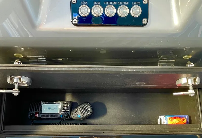 Slide: The Image of Boat dashboard with control panel and storage compartment, featuring a radio and smartphone. - 25