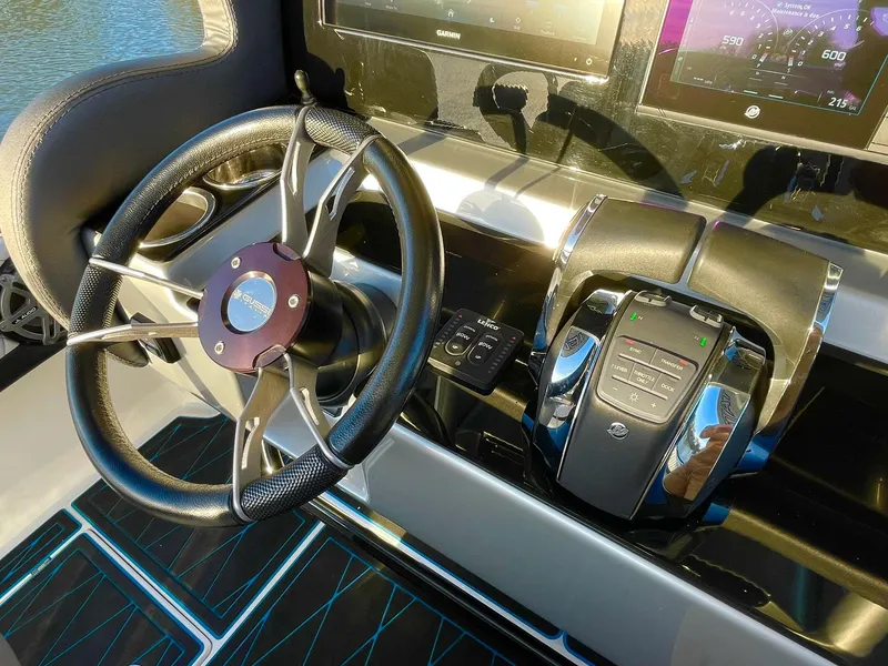 Slide: The Image of Steering wheel and controls of a 2020 Statement 350 Open boat. - 27
