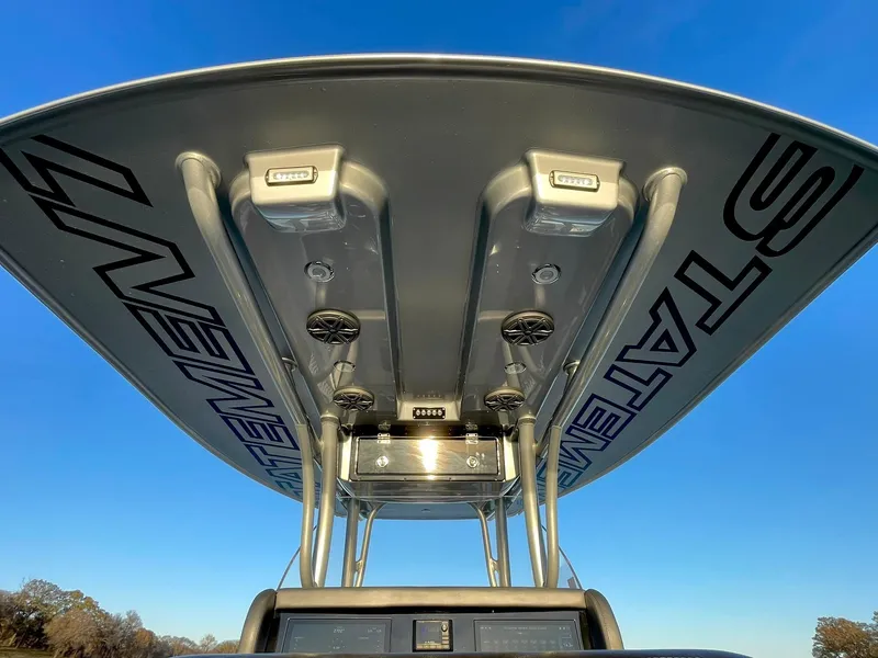 Slide: The Image of 2020 Statement 350 Open boat, view of T-top and electronics against clear blue sky. - 36