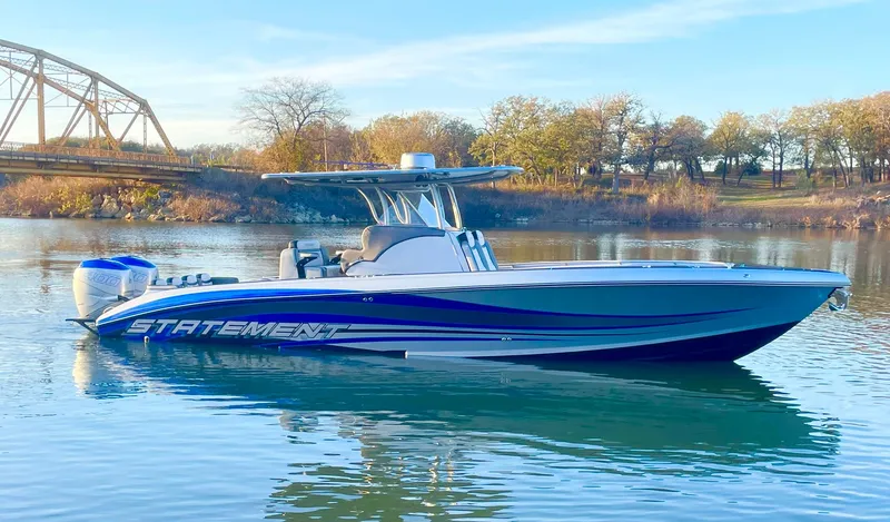 Slide: The Image of 2020 Statement 350 Open boat on calm water with scenic background. - 38