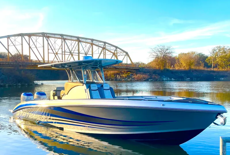 Slide: The Image of 2020 Statement 350 Open boat on calm river near a bridge. - 41