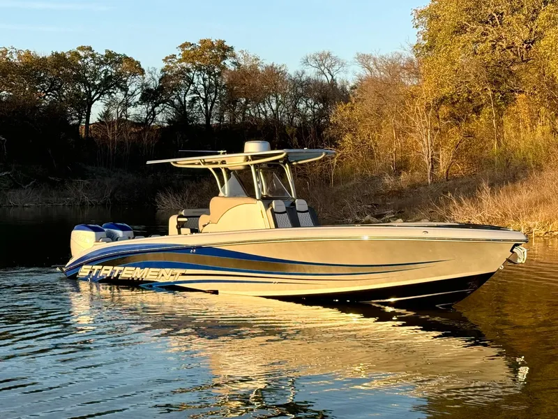 Slide: The Image of 2020 Statement 350 Open boat on calm water, surrounded by autumn trees. - 42