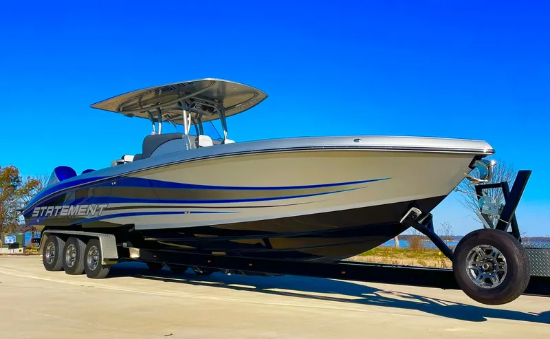 Slide: The Image of 2020 Statement 350 Open boat on trailer under clear blue sky. - 5