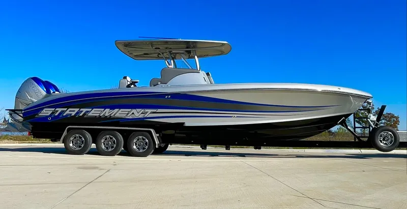 Slide: The Image of 2020 Statement 350 Open boat on trailer, sleek design, blue and white color scheme. - 6
