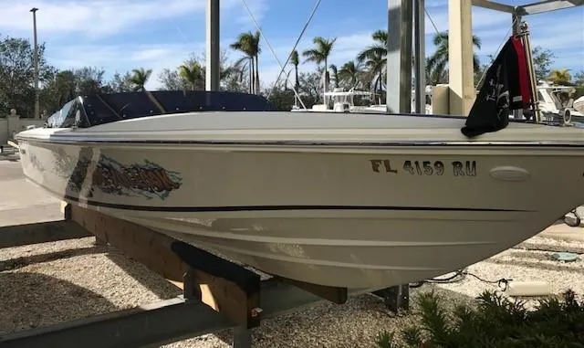 Slide: The Image of 2018 Donzi 22 Classic boat on a lift, palm trees in background. - 0