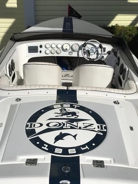 Slide: The Image of 2018 Donzi 22 Classic boat interior with logo and dashboard view. - 11