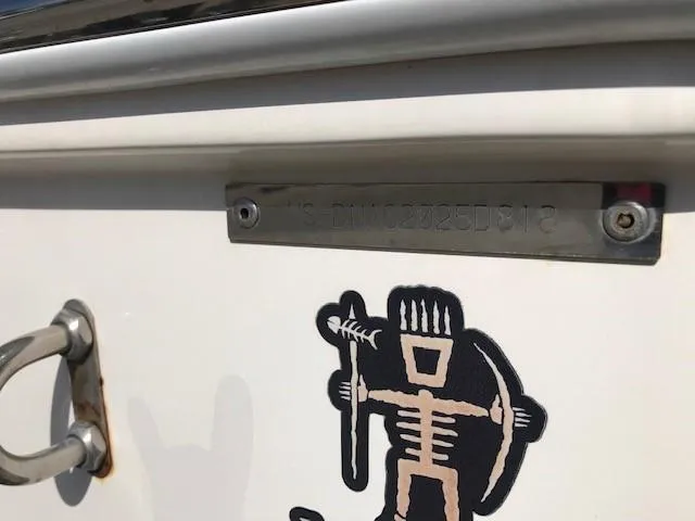 Slide: The Image of 2018 Donzi 22 Classic boat with tribal design and identification plate. - 25